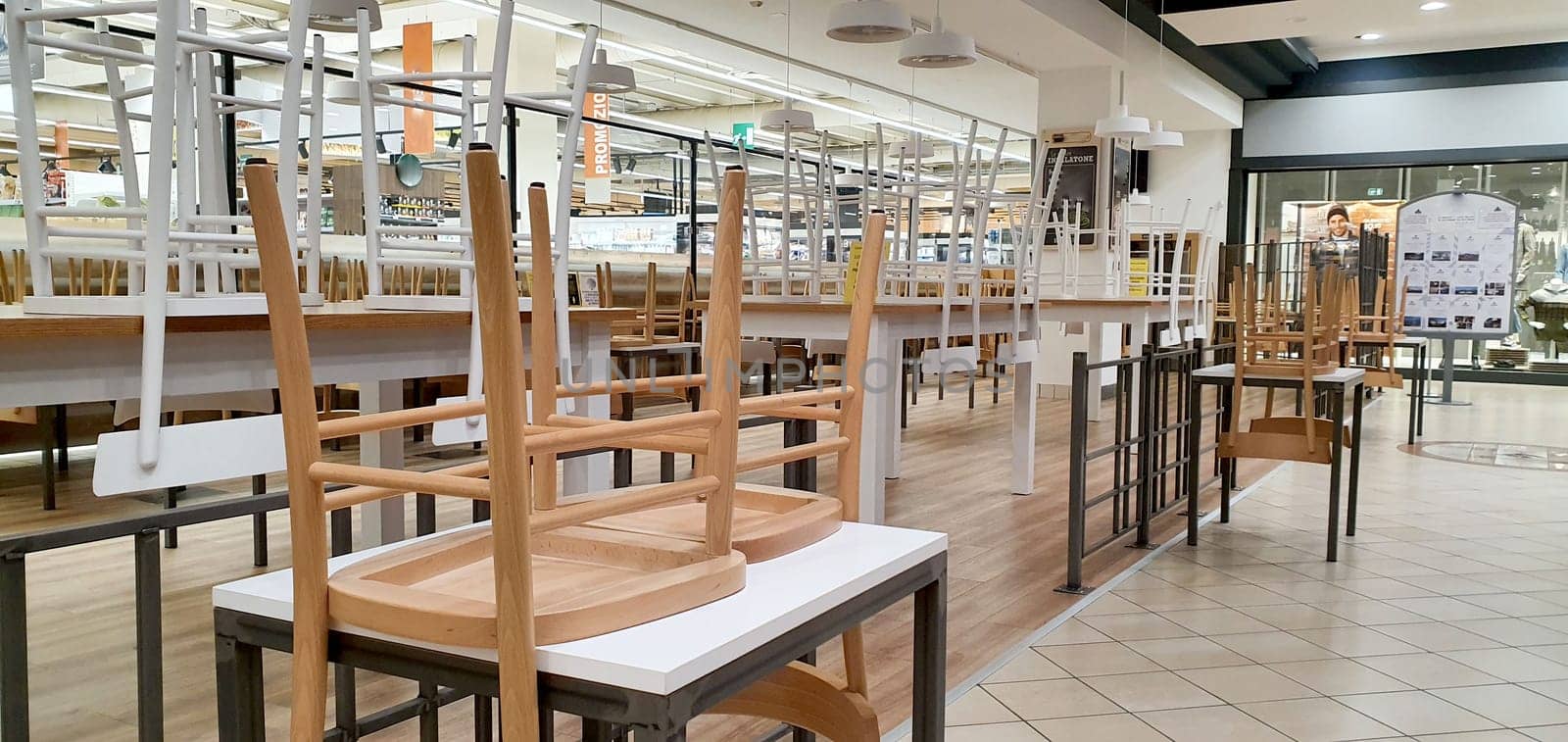 empty food and restaurant client-side area with chairs upside-down for quarantine and lockdown in COVID-19 times