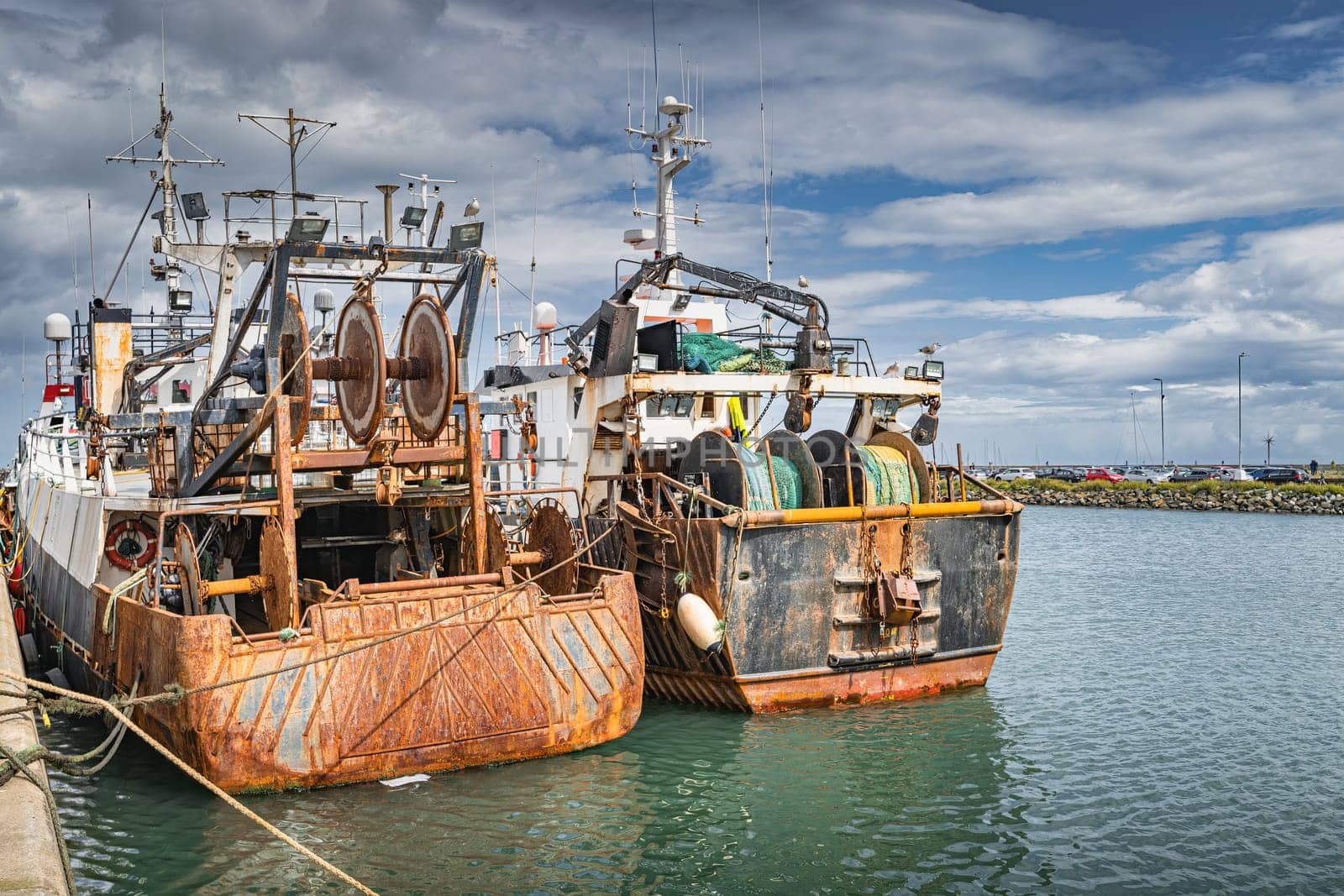 Two old and rusty fishing boats moored in Howth harbour. Phishing and shellfish fishing equipment on fishing boats, Dublin, Ireland