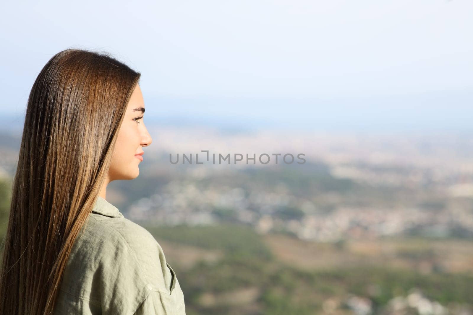 Serious teen contemplating views in city outskirts
