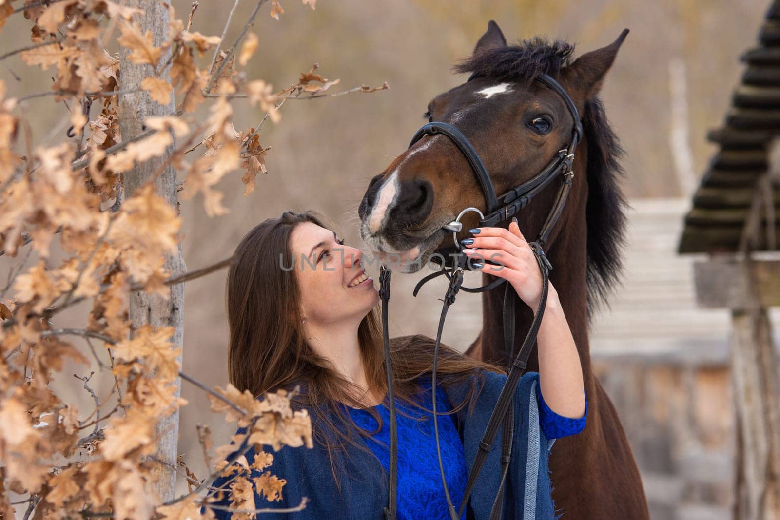 Close-up portrait of a horse and a beautiful girl of Slavic appearance