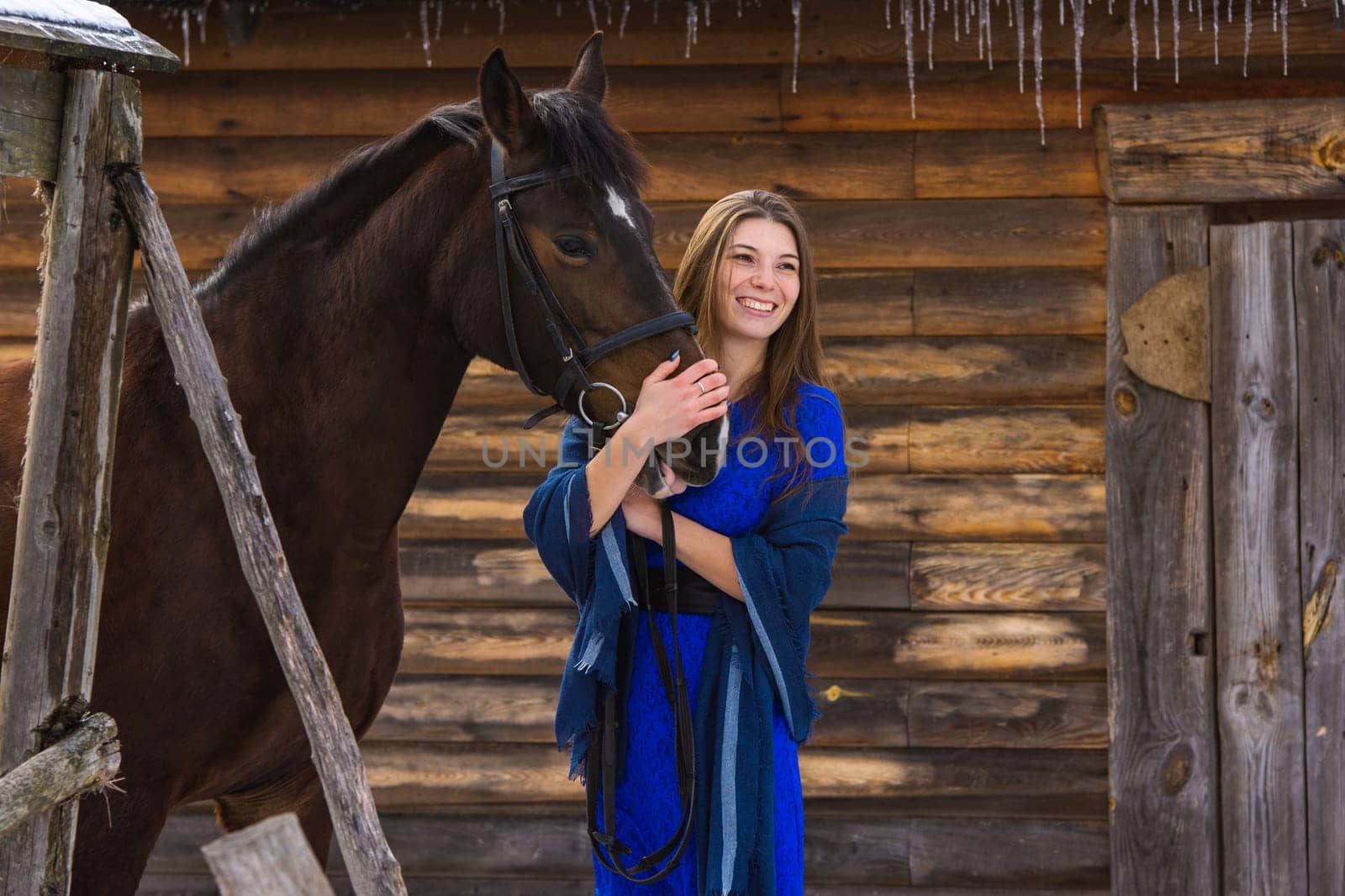 Happy girl hugging a horse and looking into the distance