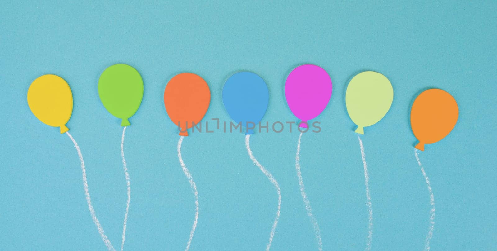 Colorful ballons on a blue colored background, children birthday greeting card, happy holiday, copy space for text