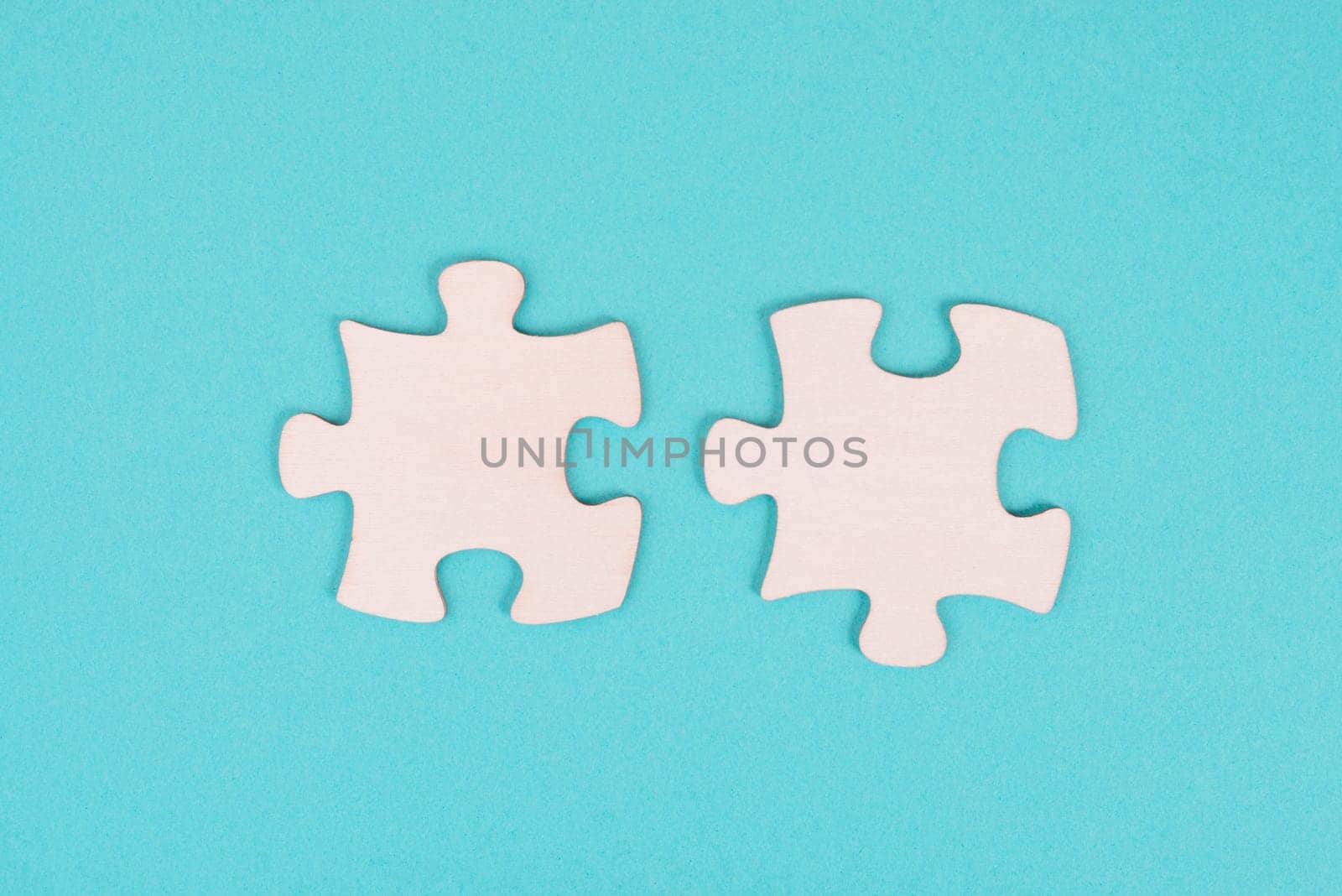 Two pieces of a puzzle, connecting together as a team, solving a problem, strategy and communication concept
