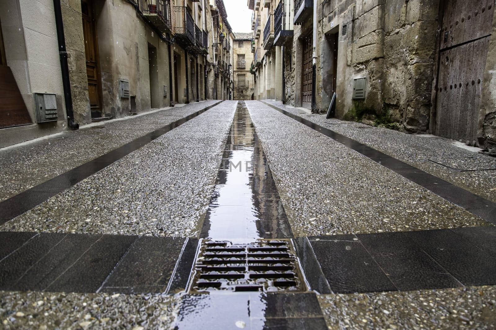 Wet stone street in old town, construction and architecture