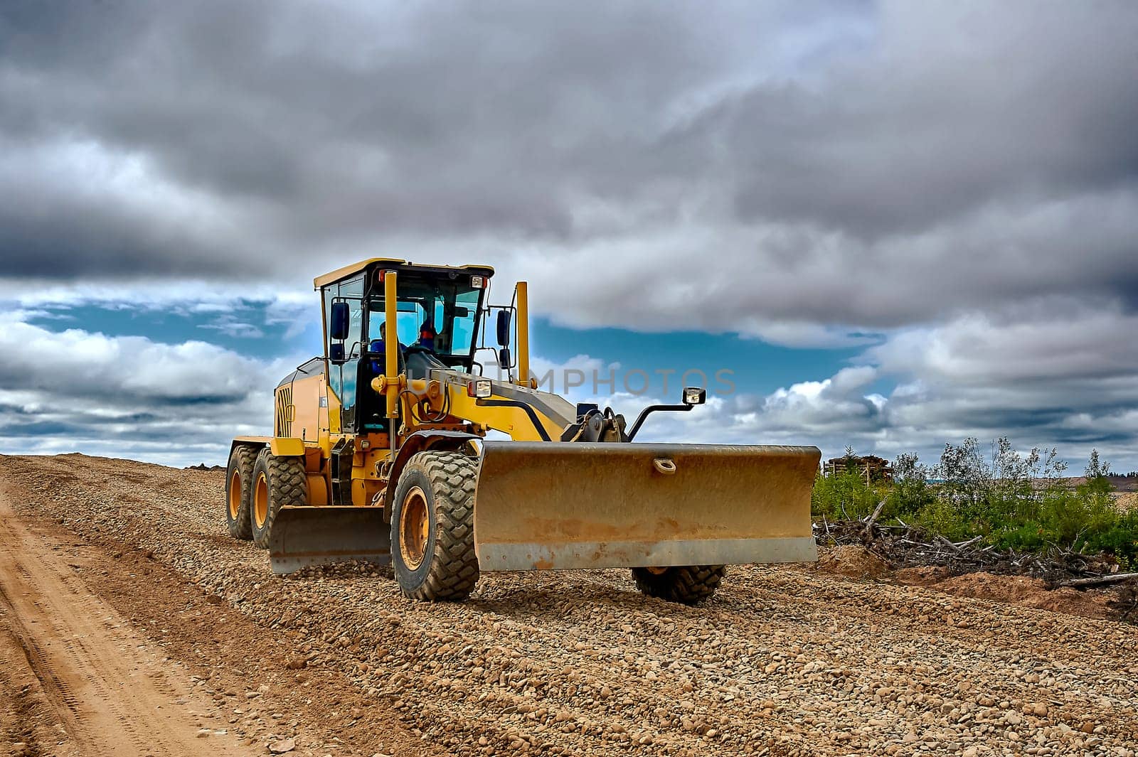 a grader on the construction site levels the rubble. High quality photo