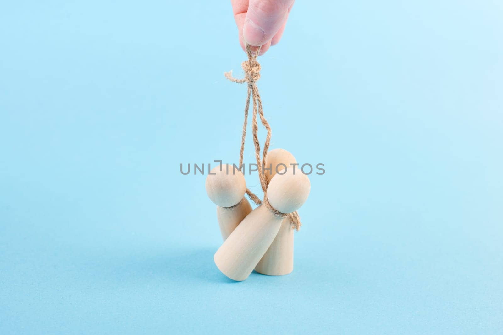 Holding and manipulating men with a string, brainwashing and controlling concept, people obey leader, political dictator and tyrant