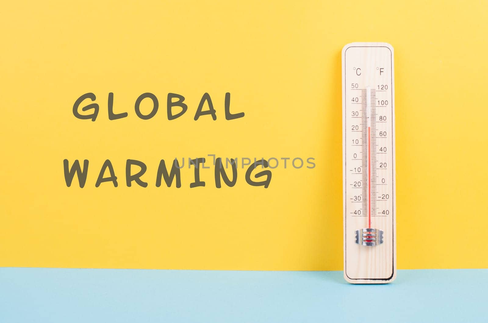 Thermometer on a yellow and blue colored background, measure the temperature, weather forecast, global warming and environment discussion, summer season
