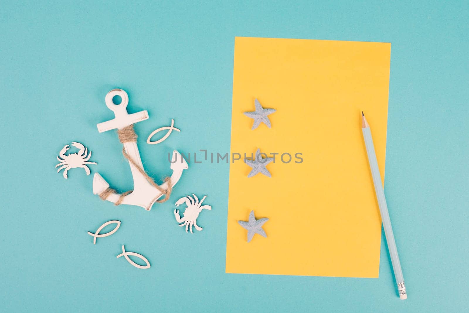 Travel list, yellow colored paper, anchor with fish sea stars and crabs, holiday plan and destination, vacation and lifestyle concept