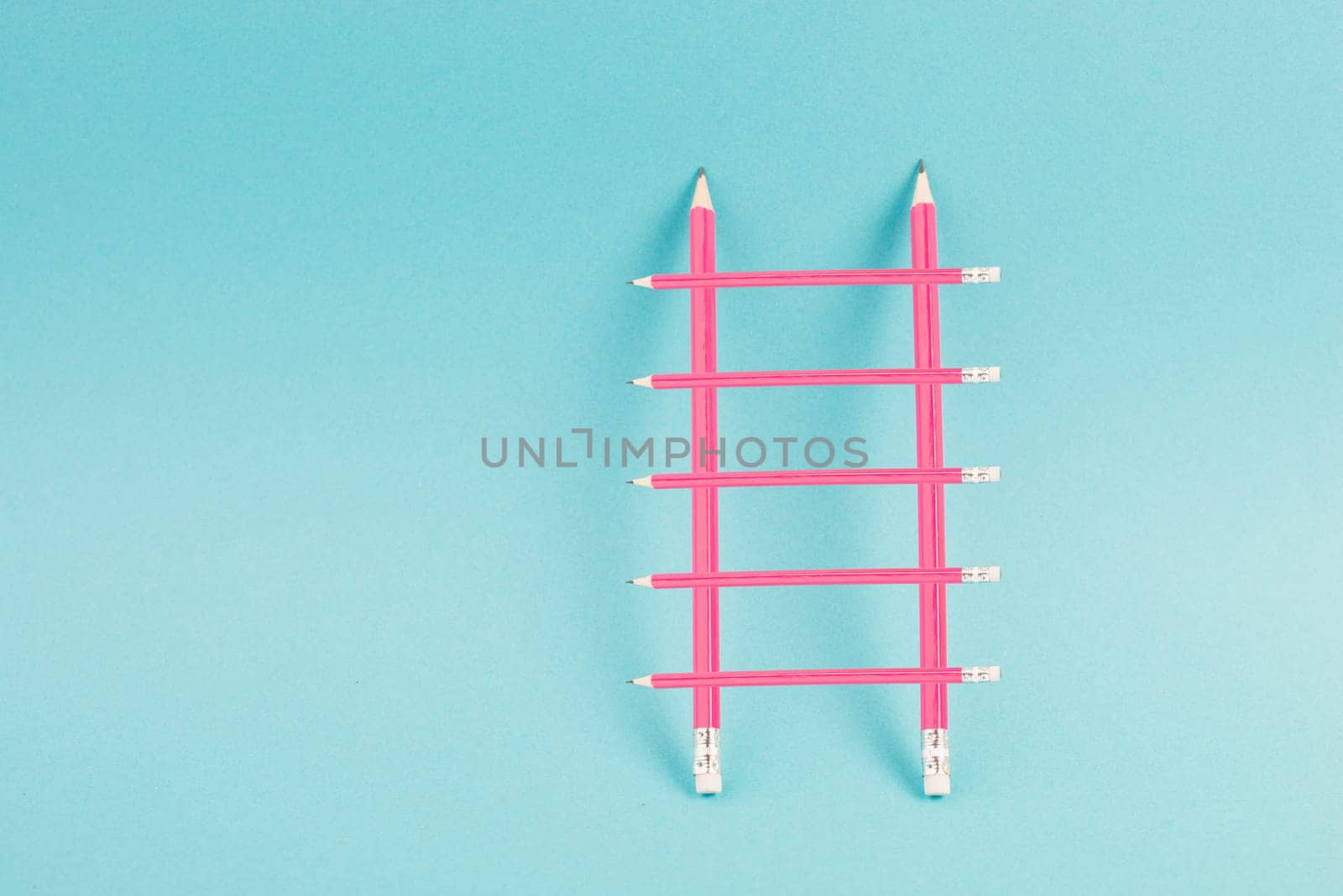 Ladder of success build with pencils, opportunity strategy, blue background, copy space for text, step by step concept, progress in business and education, have a goal