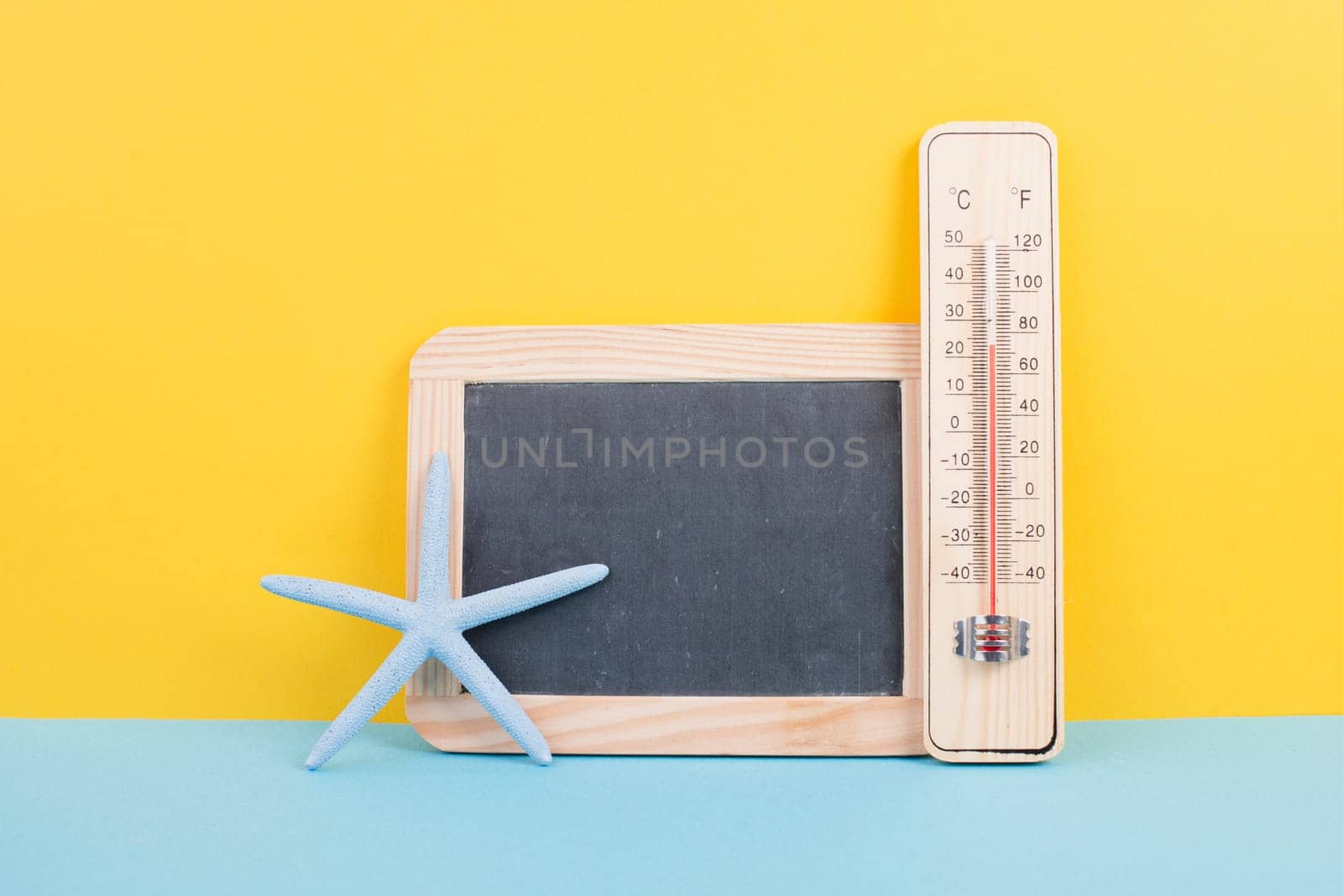 Empty chalkboard with a thermometer and an anchor, holiday background, summer vacation, hot weather, environmental issue