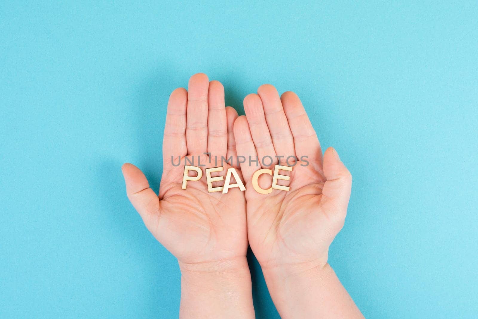 Holding the word peace in the hands, stop war, support Ukraine, living peaceful together