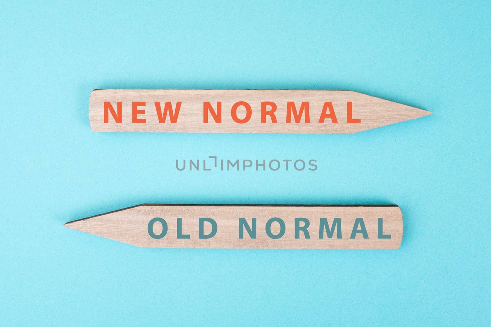 The words new and old normal are standing on wooden arrows, transformation of society after pandemic, strategy for the future