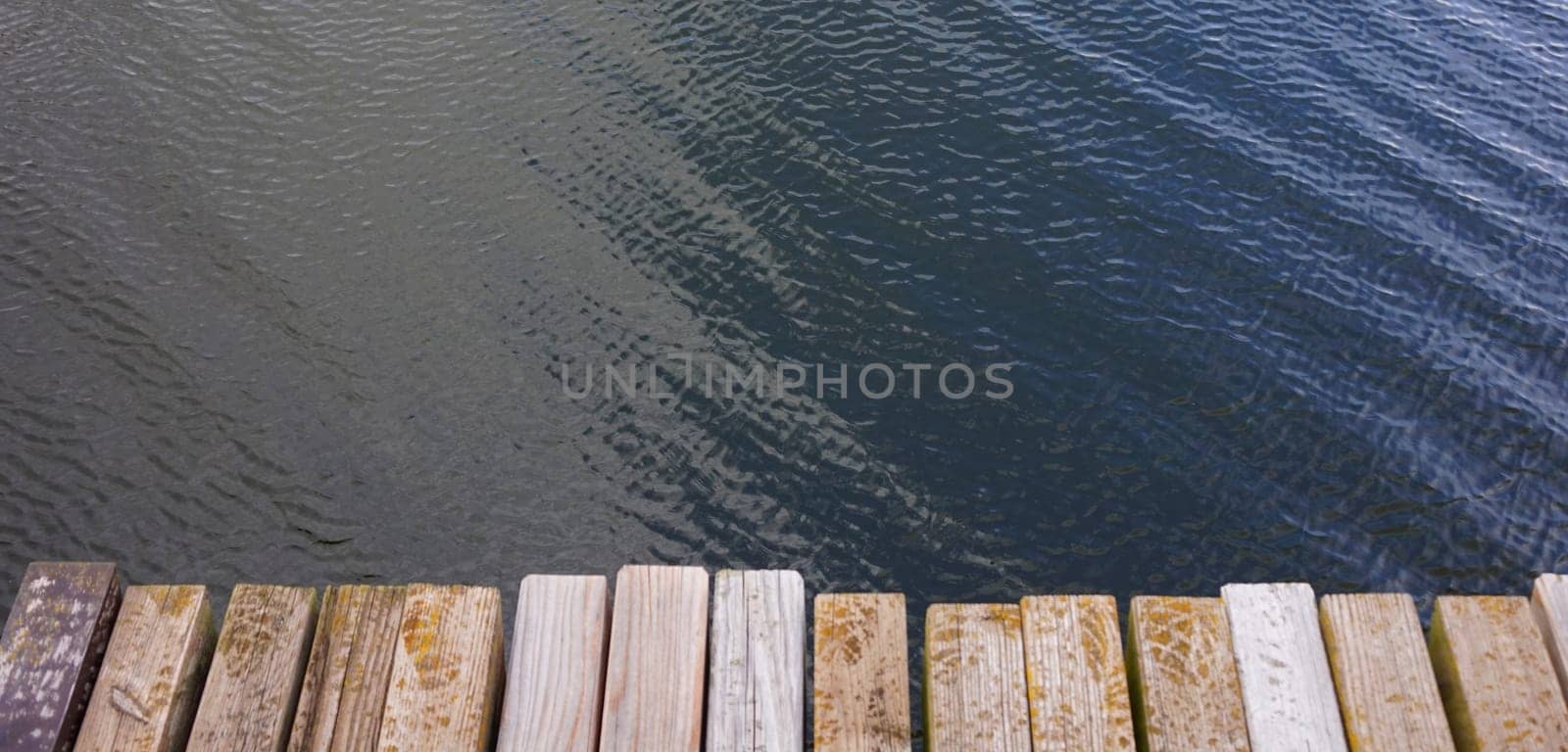 Holzsteg mit Planken aus Holz an einem See