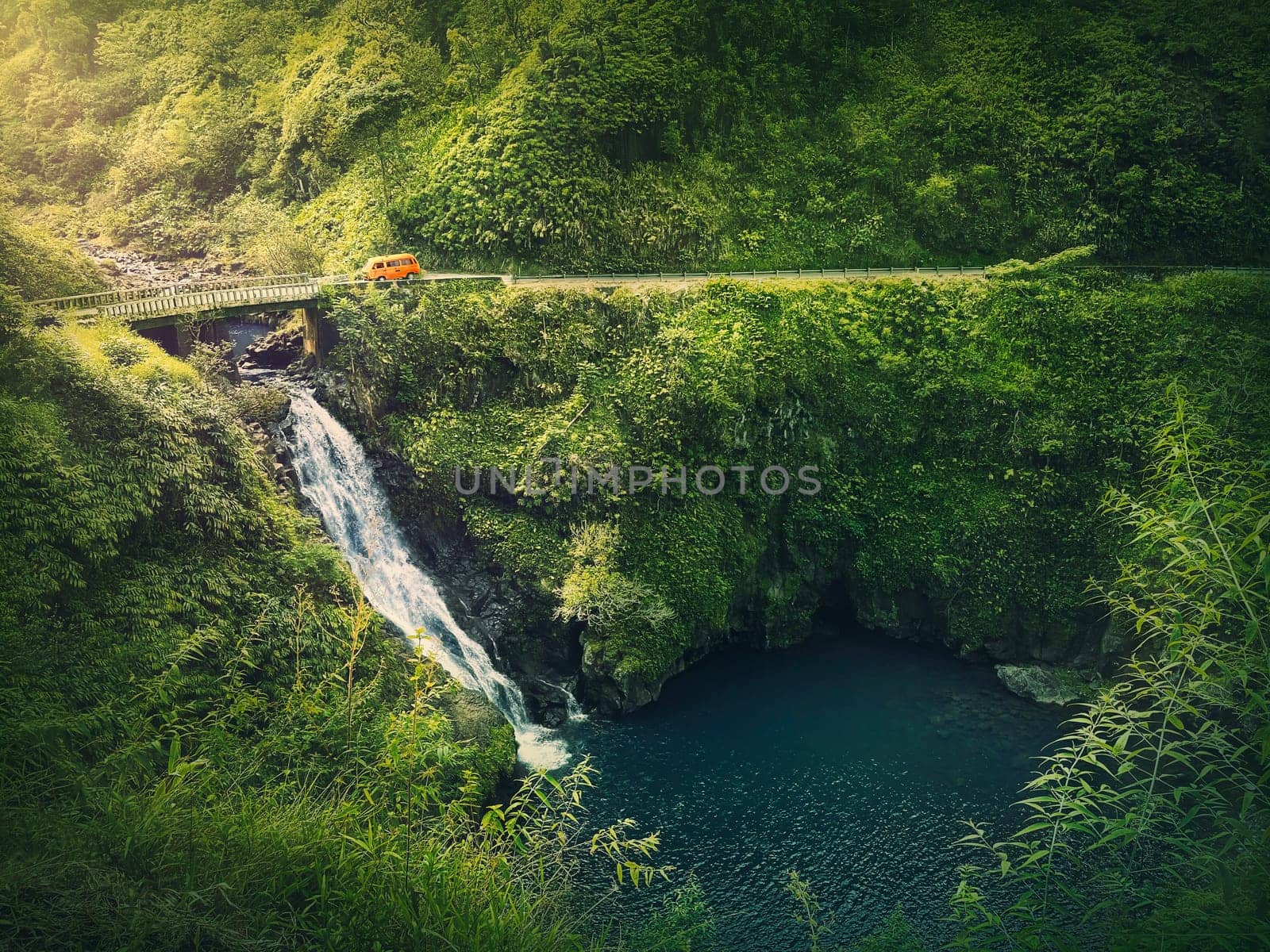 Makapipi Falls of Maui, the Road to Hana in Hawaii. Beautiful waterfall underneath the highway bridge. Wonderful cascade in the in hawaiian rainforest among tropical green fern vegetation