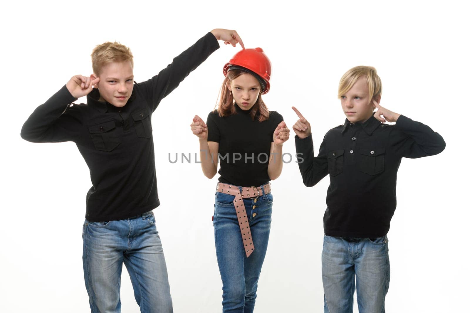 Two boys are disgusted by the presence of a girl, a girl in a hard hat and shows them a figure