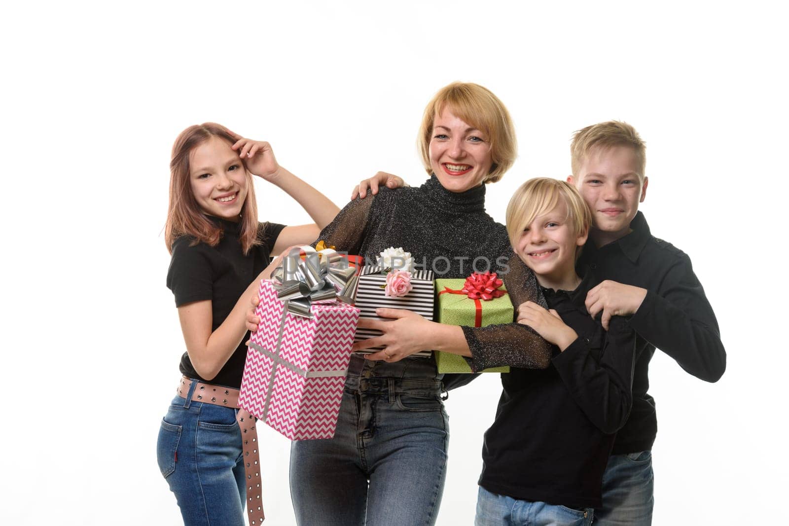 Children congratulated their mother on her birthday, look into the frame together and smile