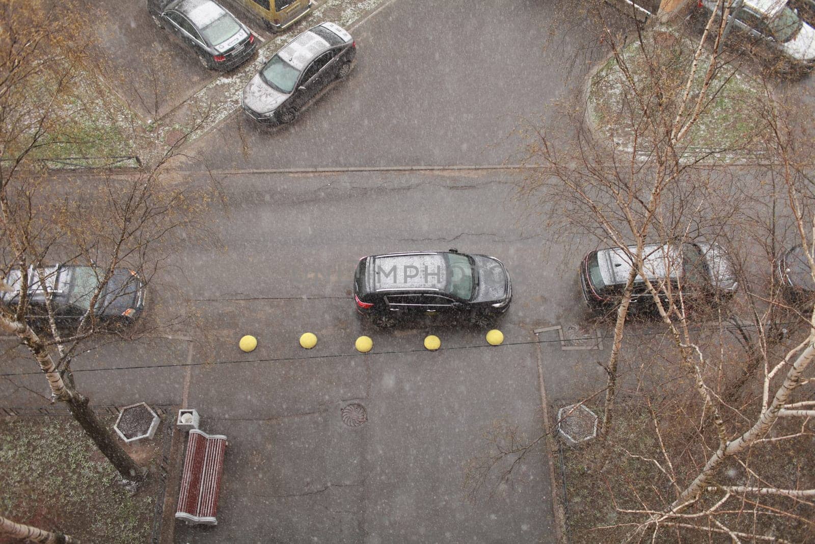 snowfall winter, top view of the road and parked cars