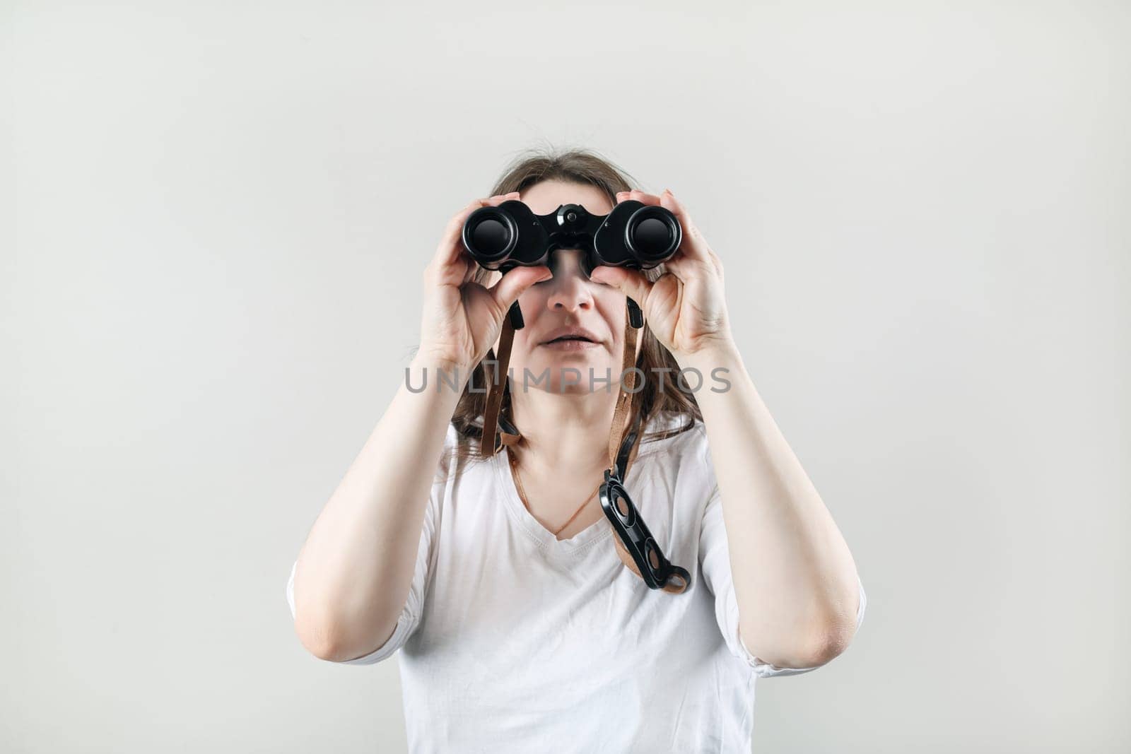 Woman with binocular. Businesswoman looking through binoculars.