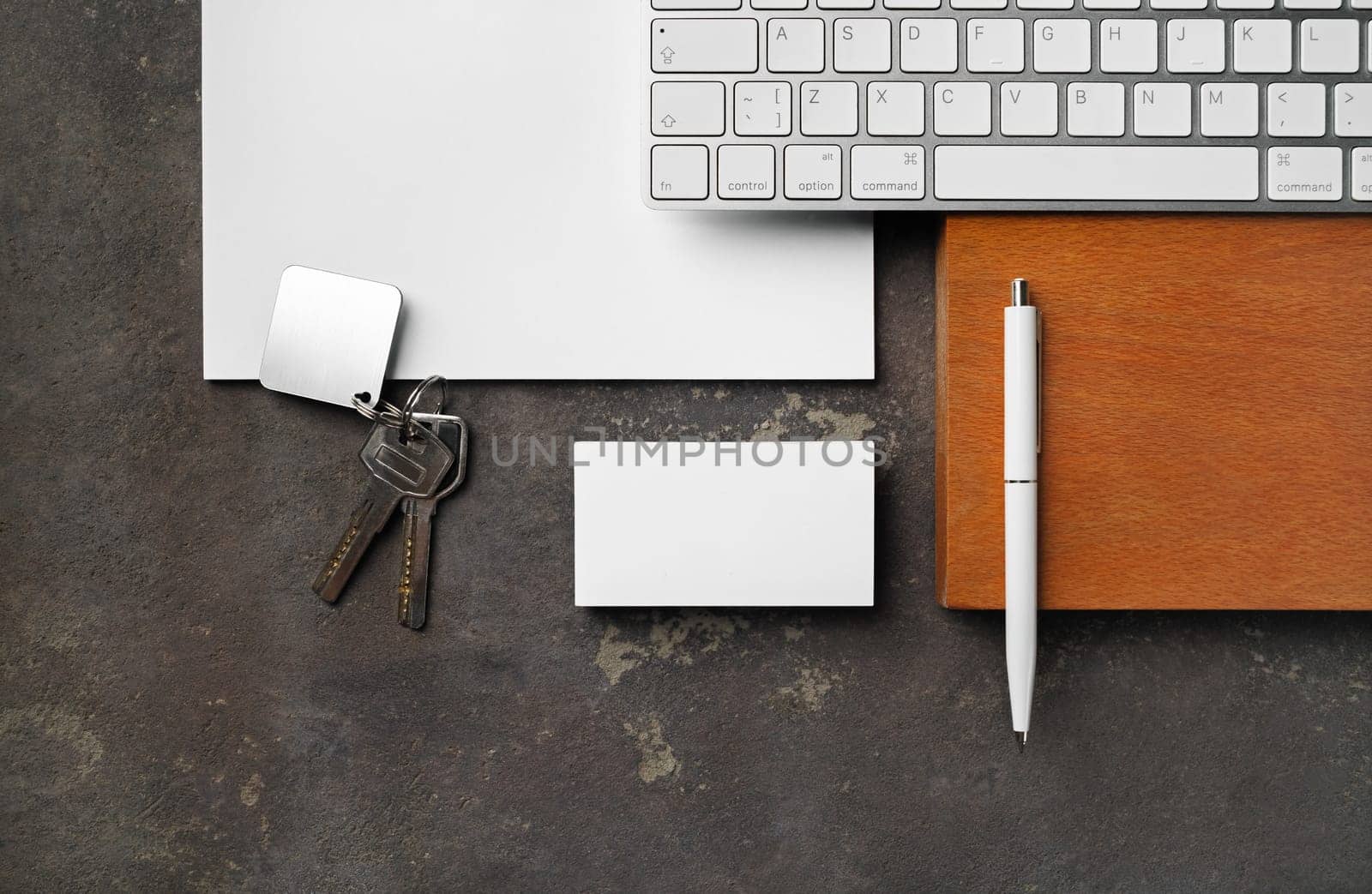 Blank real estate agency stationery set. Blank business card, key, keyboard, pen and paper. Flat lay.