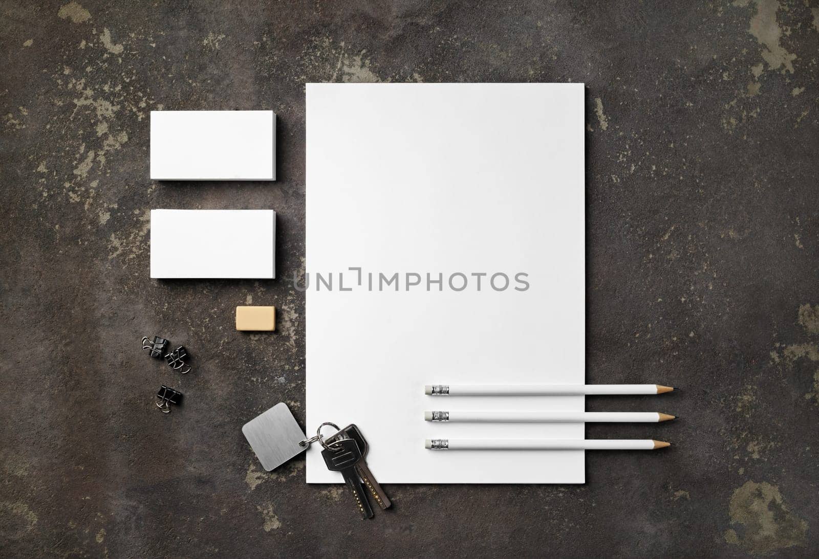 Blank stationery set and keys on concrete background. Blank objects for placing your design. Flat lay.