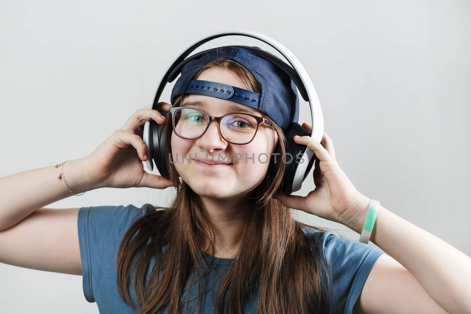 Smiling teen girl listening music in headphones. Enjoy music.