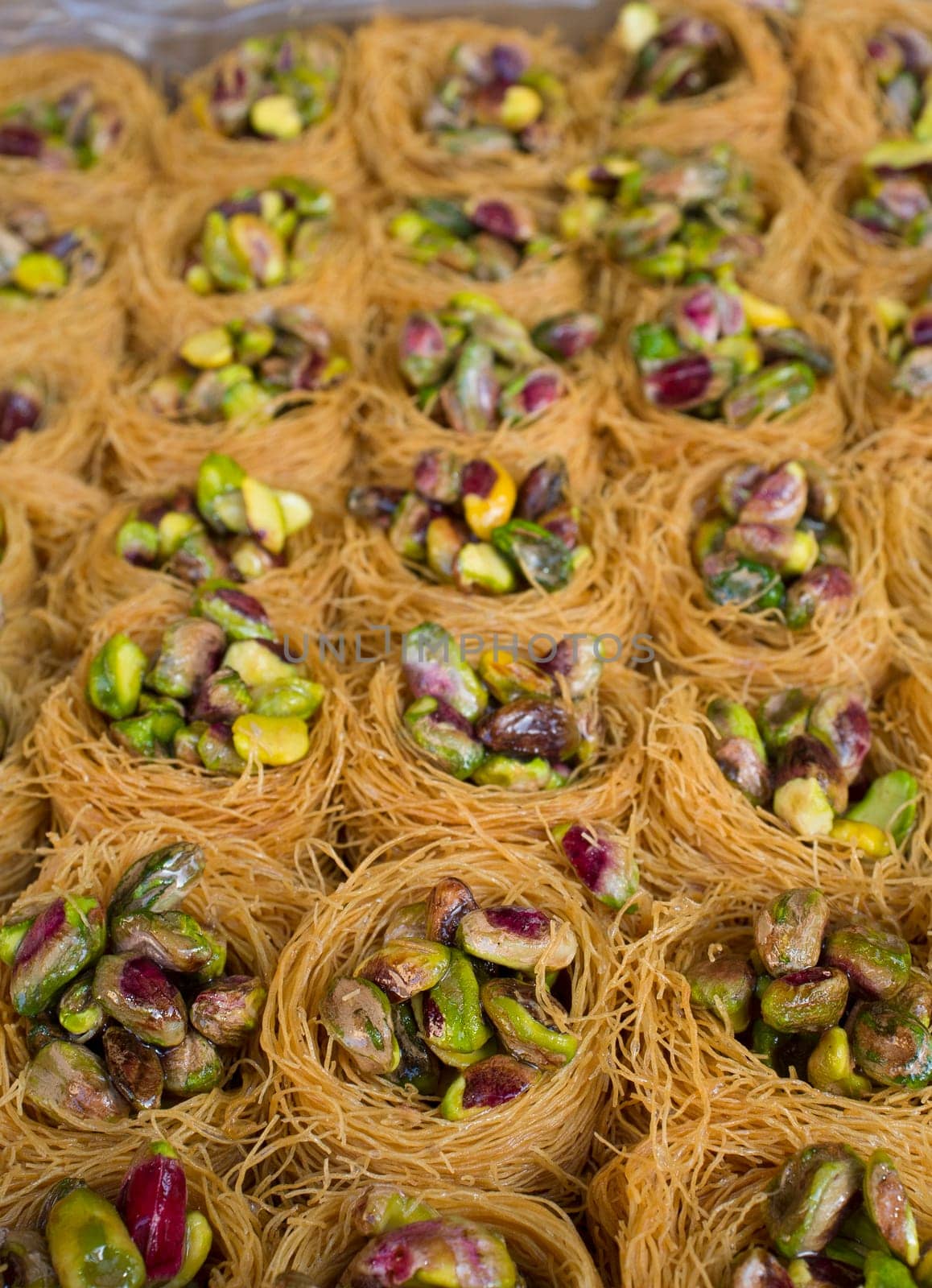 Platter crammed with Nightingales Nests or Ouch El Boulboul. Arabic dessert with pistachio