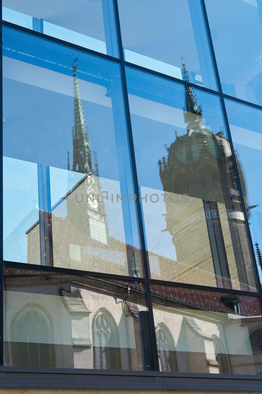 Reflection of the castle church Schlosskirche in Wittenberg in Germany in the glass of a window