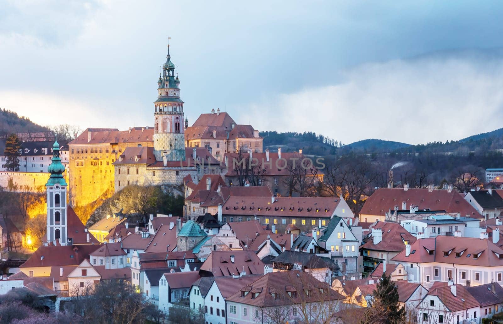 Beautiful view to Cesky Krumlov castle and its tower in Czech republic at sunset with dramatic clouds. Horizontally.