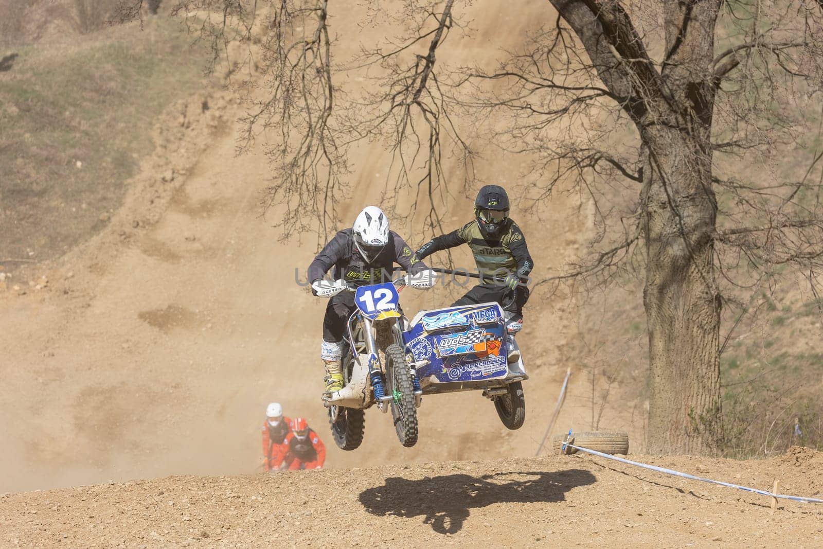 MOHELNICE, CZECH REPUBLIC - APRIL 16, 2022. Pair crews of sidecacross motorbike are jumping together in the "Sidecarcross Championship of Czech Republic"" on April 16, 2022 in the town of Mohelnice."