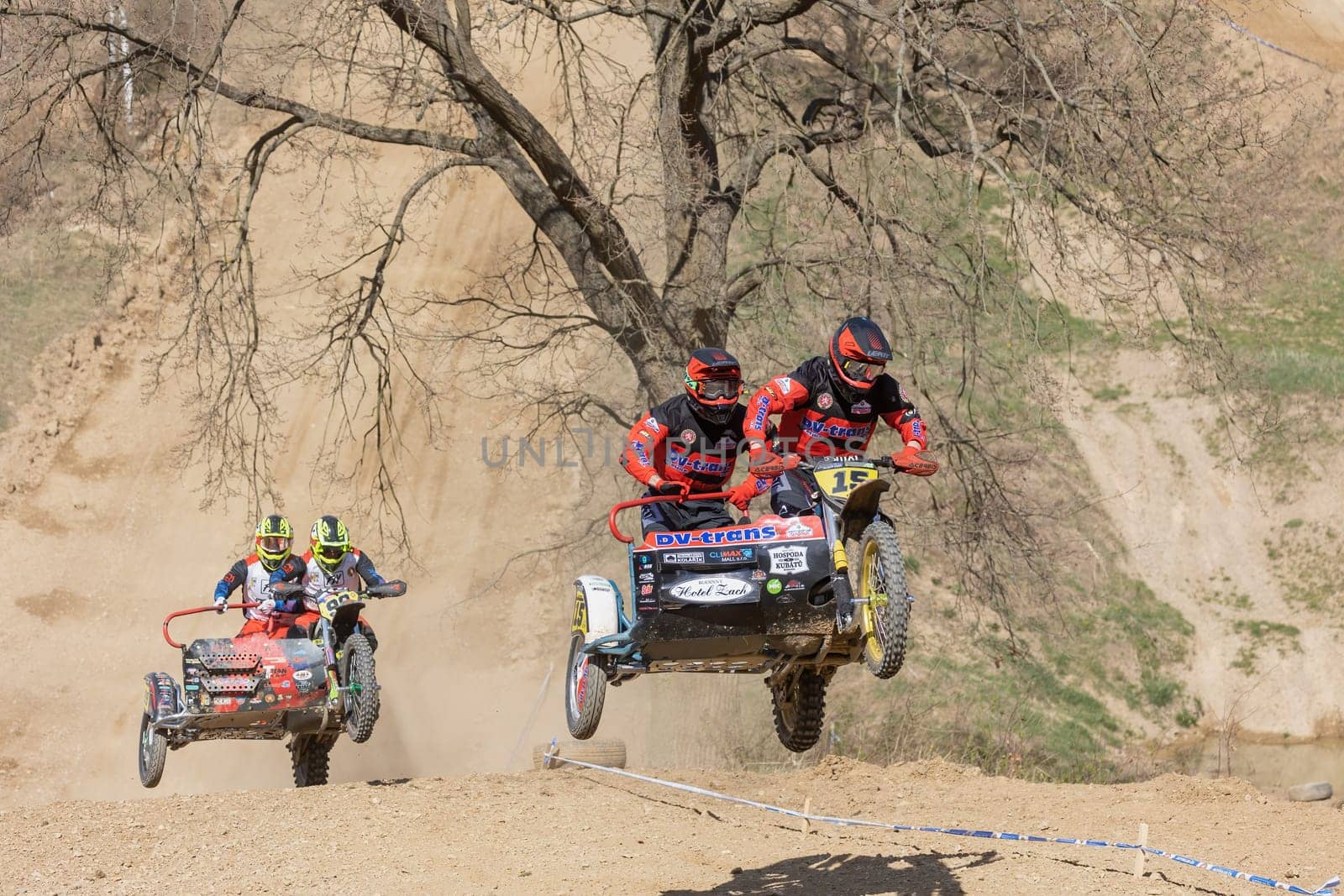 MOHELNICE, CZECH REPUBLIC - APRIL 16, 2022. Two crews of sidecacross motorbike are jumping together in the "Sidecarcross Championship of Czech Republic"" on April 16, 2022 in the town of Mohelnice."