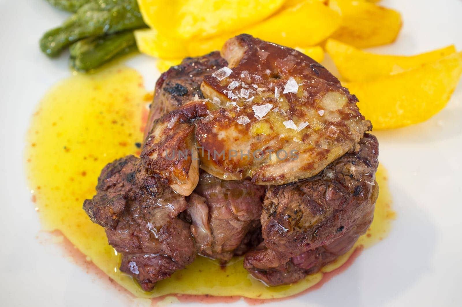 Grilled veal tenderloin with foie au gratin. Closeup