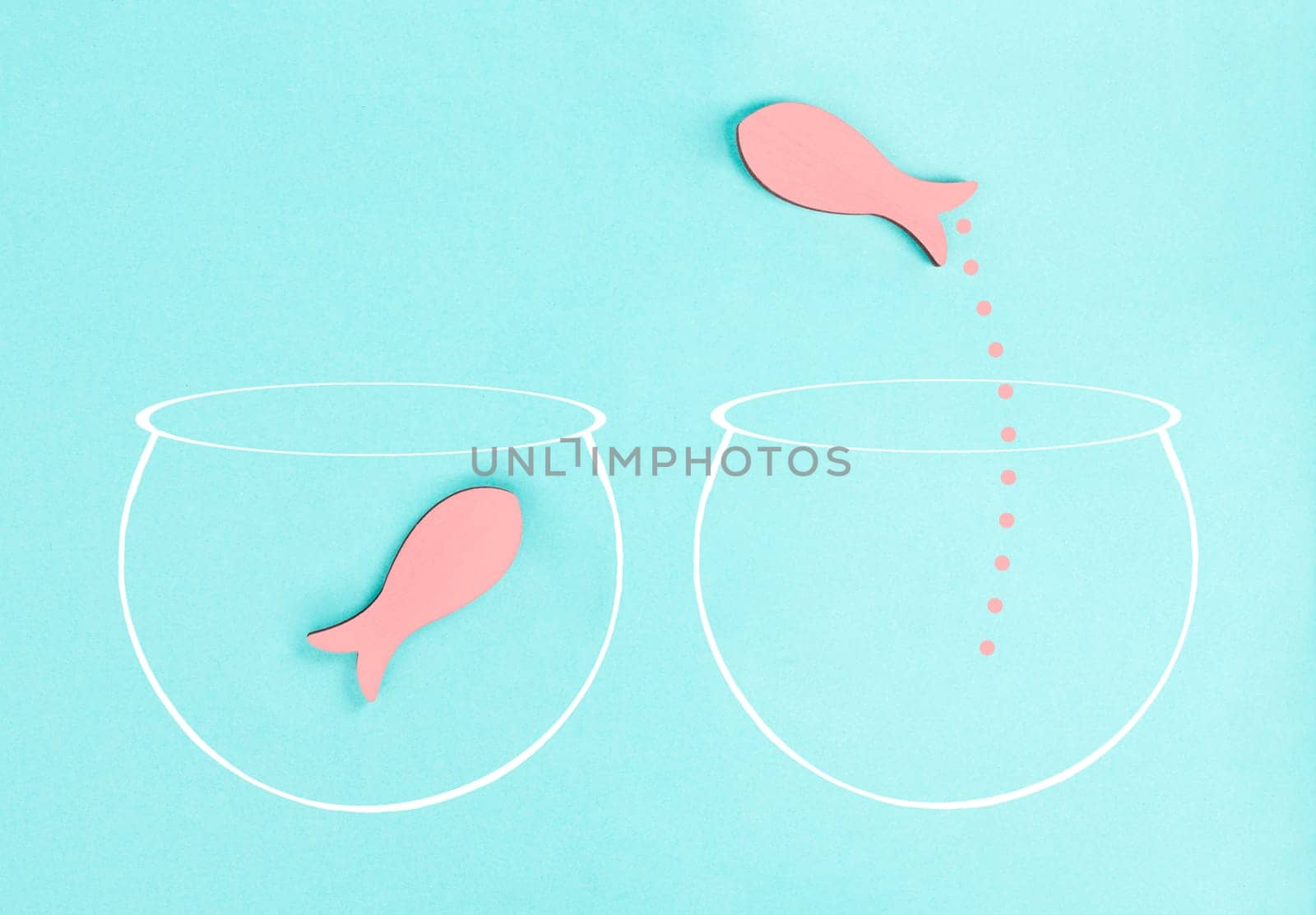 One fish is the leader of the group, leadership and teamwork concept, be a winner, success and start up in business, follow a new idea, fishes in a aquarium jump to freedom