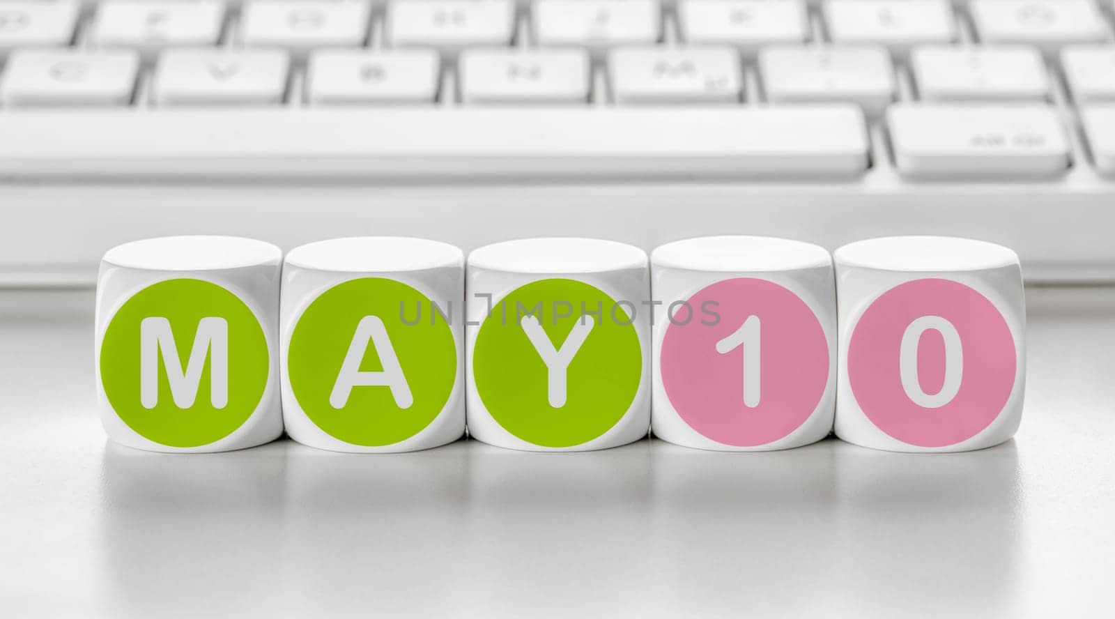 Letter dice in front of a keyboard - May 10