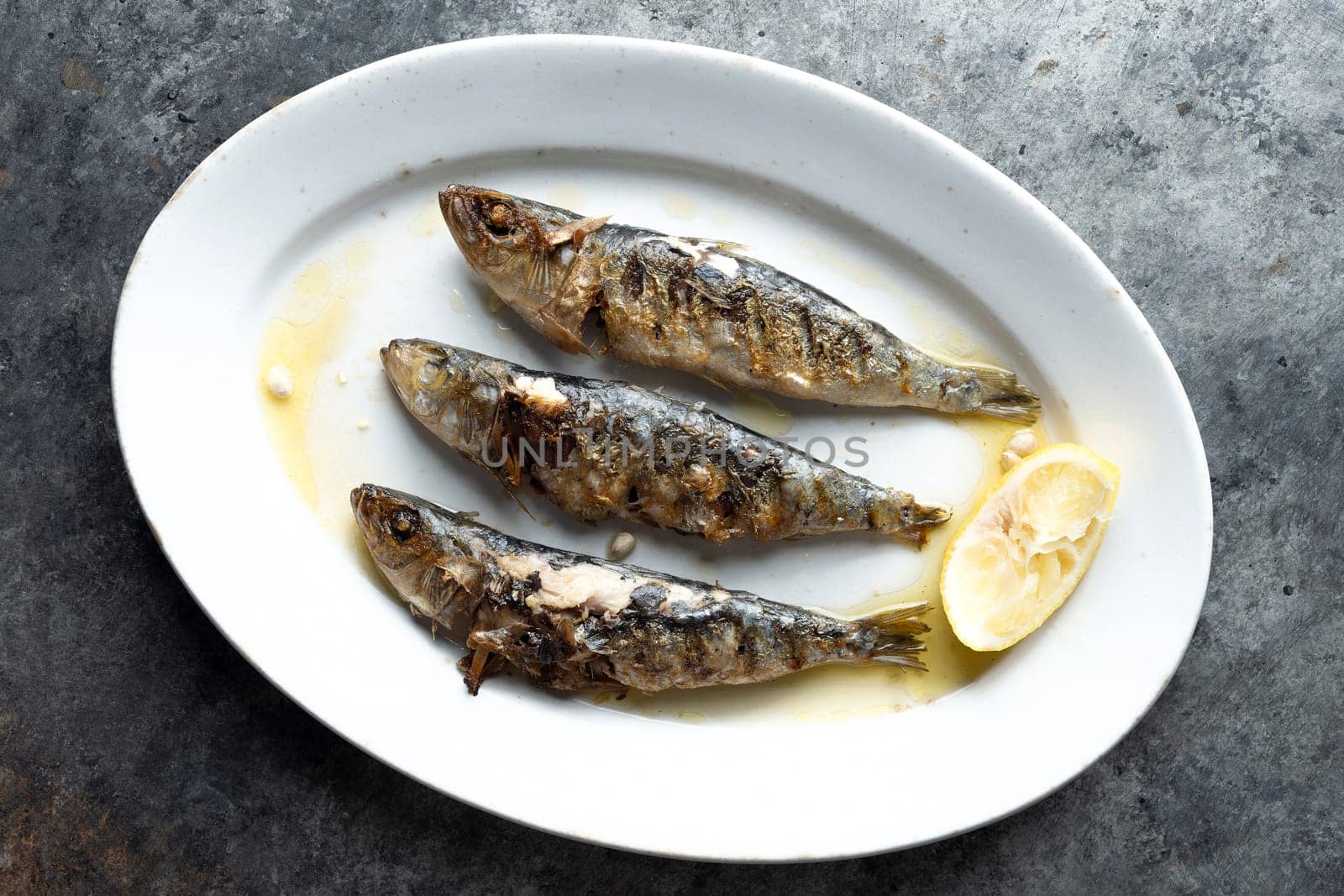 close up of plate of grilled sardines