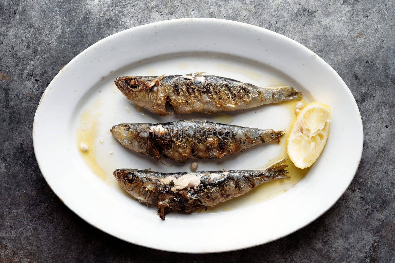 close up of plate of grilled sardines