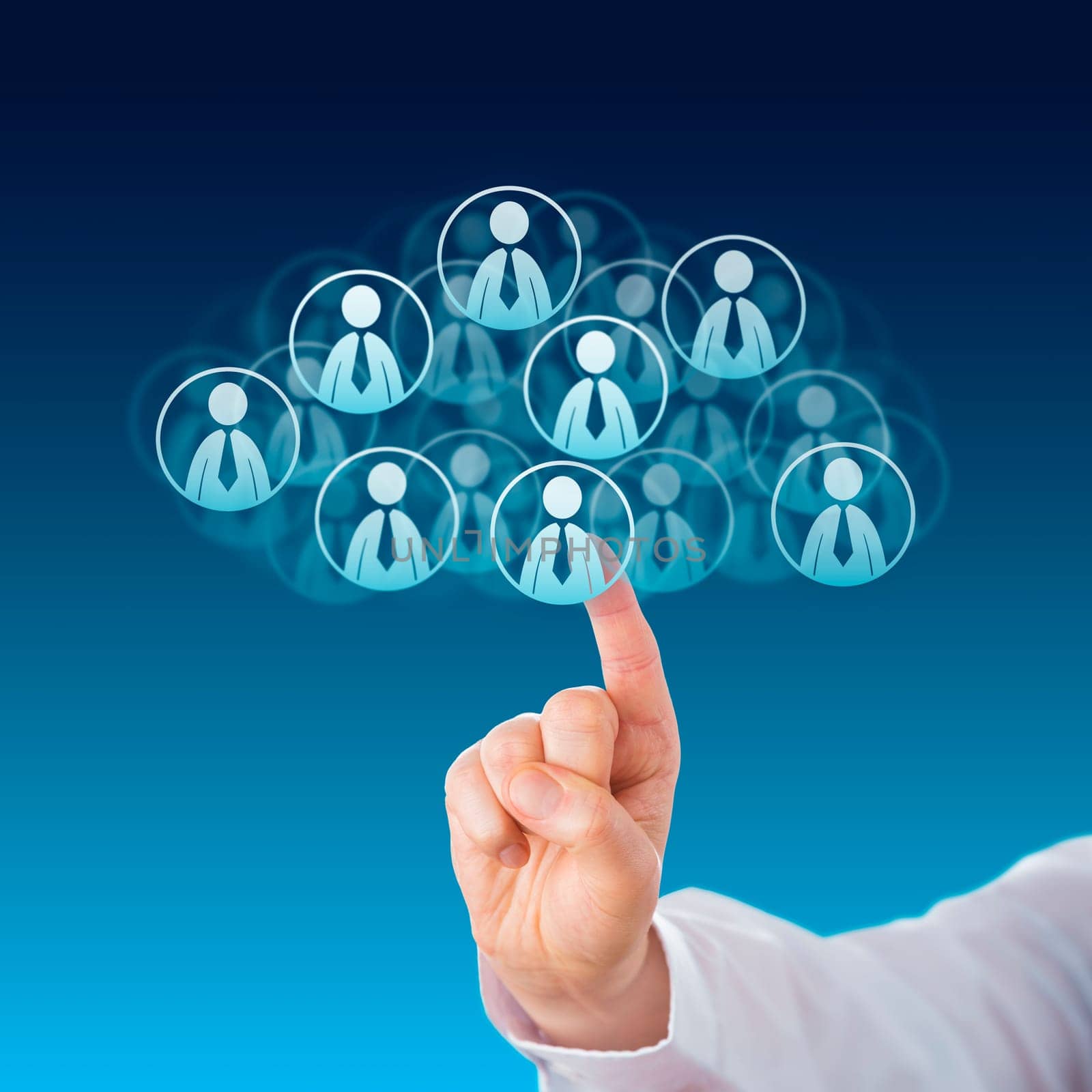 Index finger of a white collar worker touching human resources icons that shape a virtual cloud. Business metaphor for cloud computing and technology service industry. Close up on blue background.