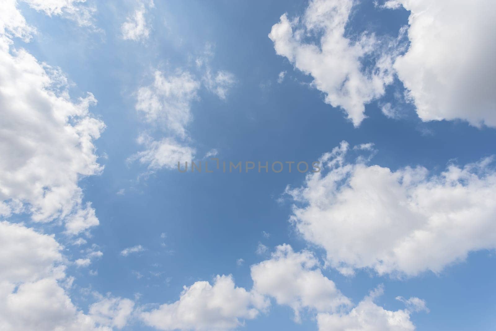 Blue sky background with white clouds.