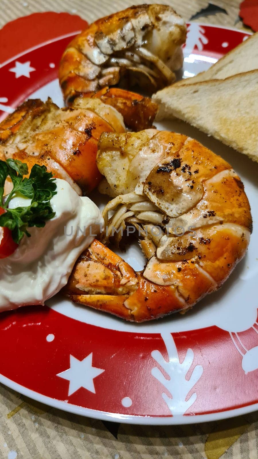 Traditional spanish tapa with prawns cooked in oil with garlic and chili. Served with slice baguette