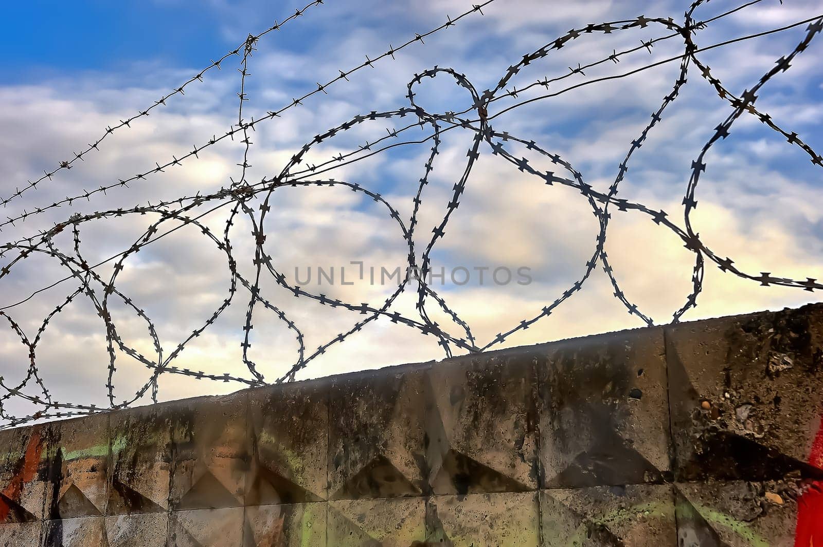 Barbed wire on a blue sky background. High quality photo