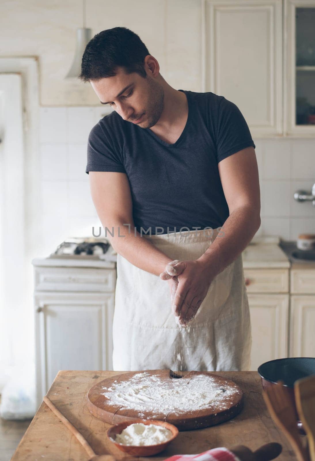 Man baking bread in kitchen.