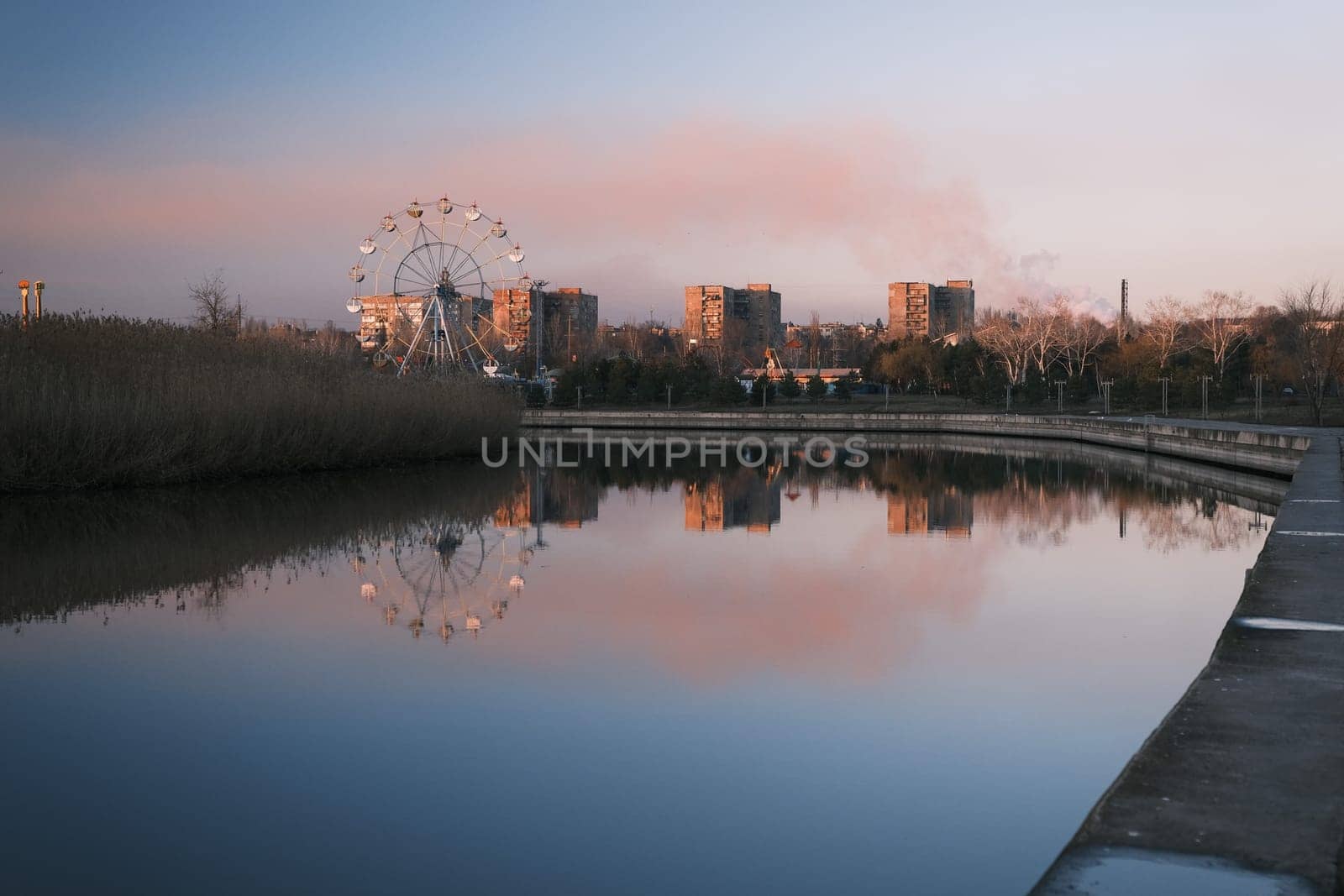 Extreme park near the river in autumn time evening, red sky beautiful sunset with red cloud on top