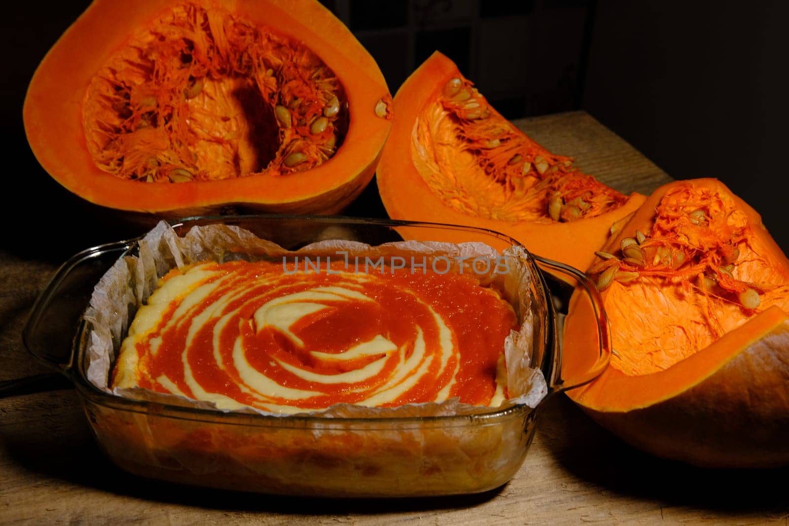 Homemade pumpkin pie cheesecake with piece of pumpkin sliced on parts. Orange dessert. SIDE VIEW.
