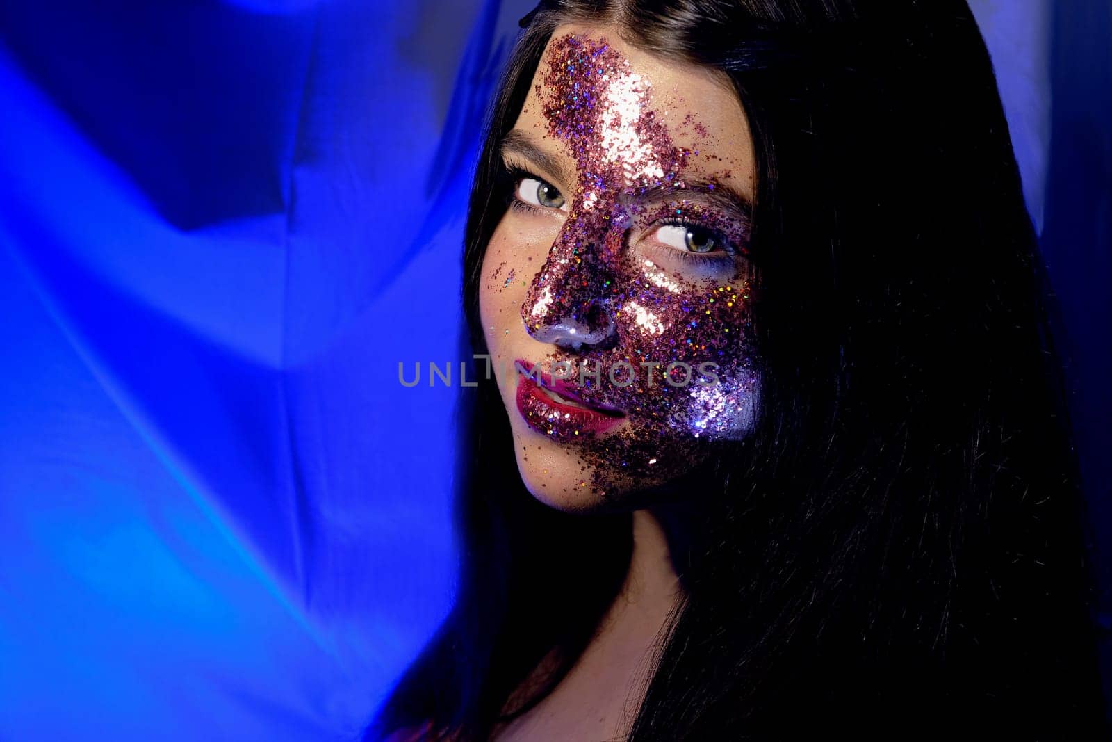 Festive makeup Fashion teen girl beauty women portrait of young model lovely fdecorated with shining glitter, people, beauty and cosmetics on blue background, glitter looks like Milky way