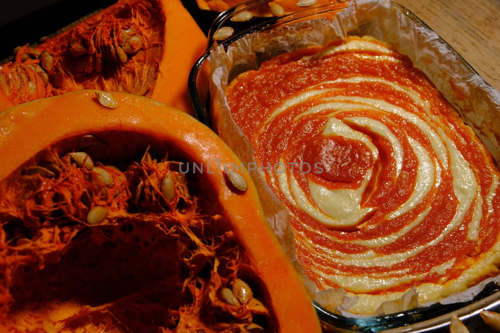 Homemade pumpkin pie cheesecake with piece of pumpkin sliced on parts. Orange dessert. vertical image. top view.
