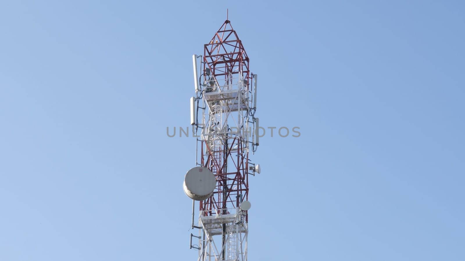 Telecommunication Cellular Tower Against Blue Sky.