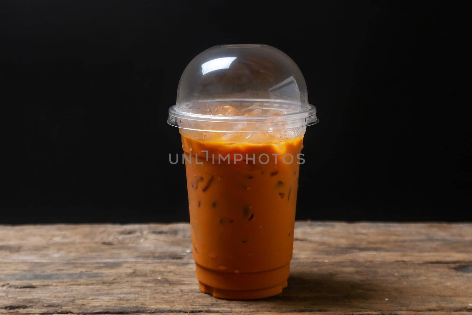 Tea thai, Ice tea milk or Ice milk tea, Sweet drink, Blurred black background