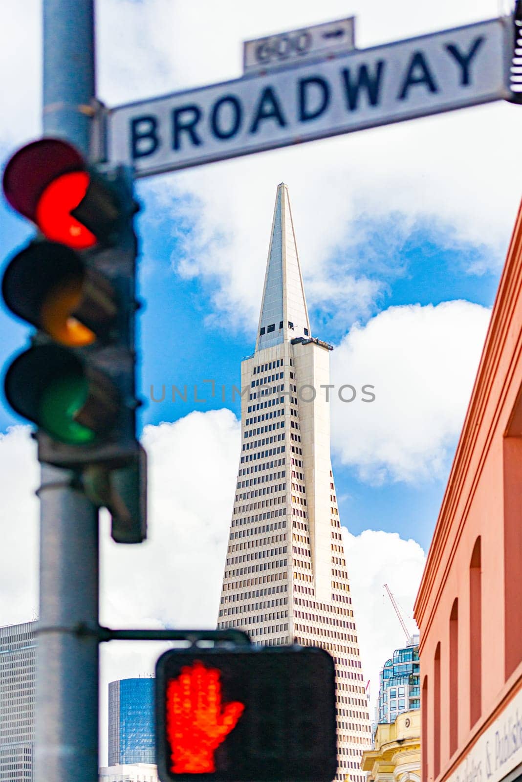 Bbroadway street sign in San Francisco, California, USA. Transamerica pyramid building in background.