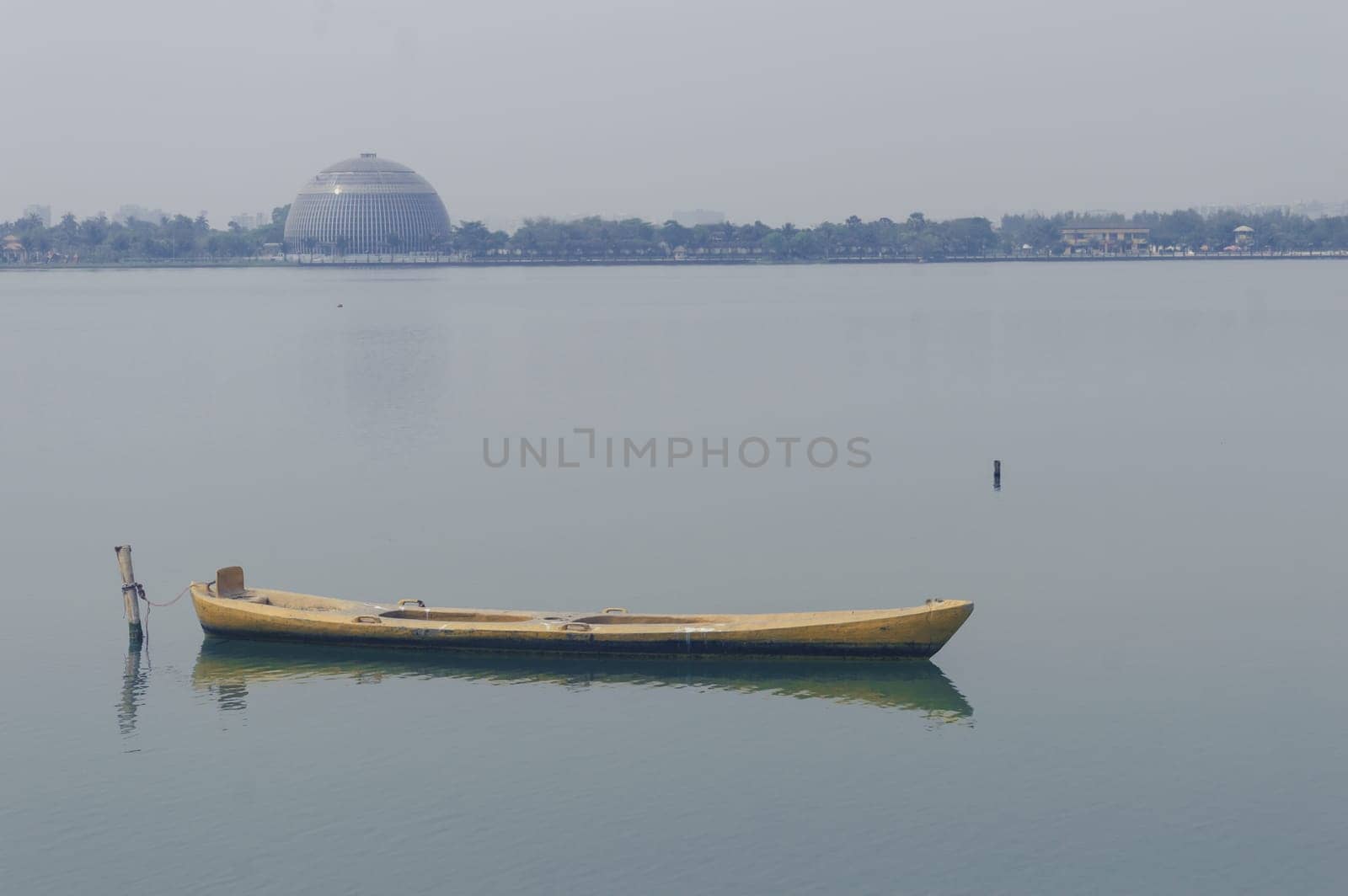 Close up view on beautiful wooden flat rowing boat moored on lake in a National recreation area. Kolkata India