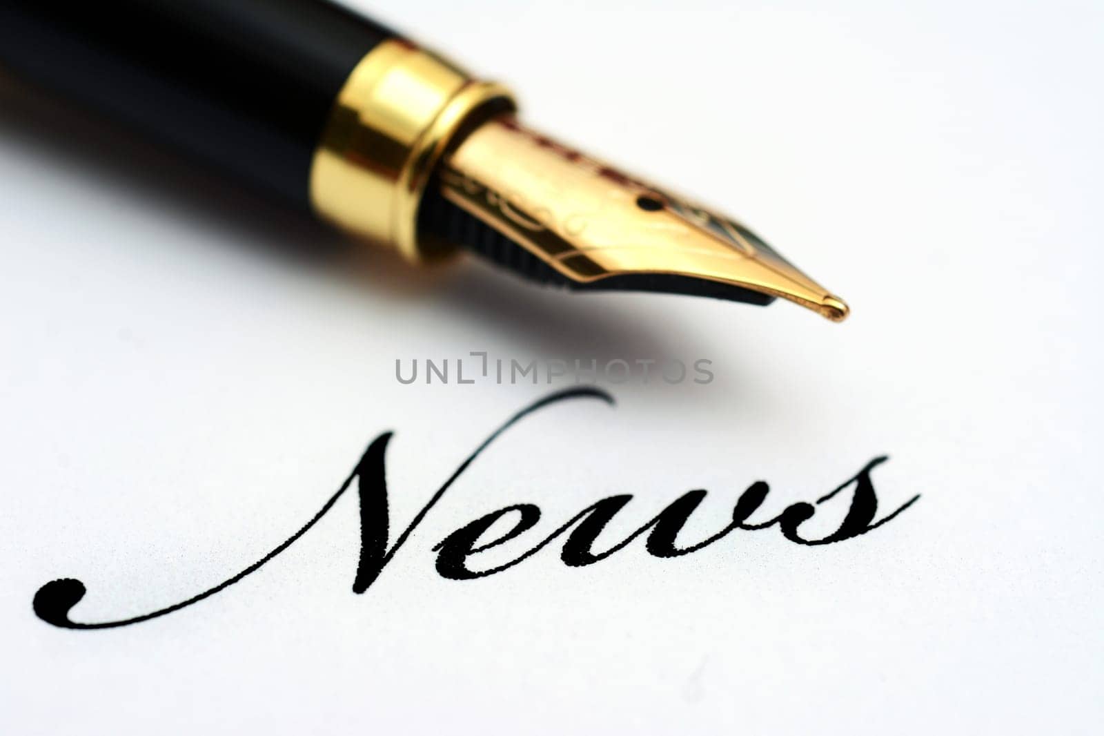 Fountain pen on news text
