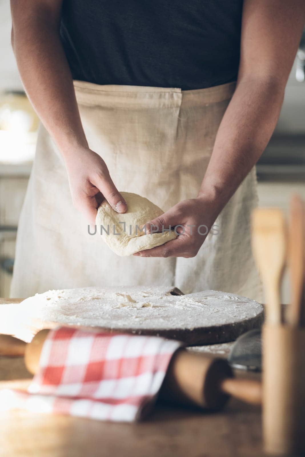 Man baking bread in kitchen.